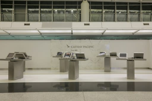 The Cathay Pacific Airways check-in area is empty after all flights were cancelled