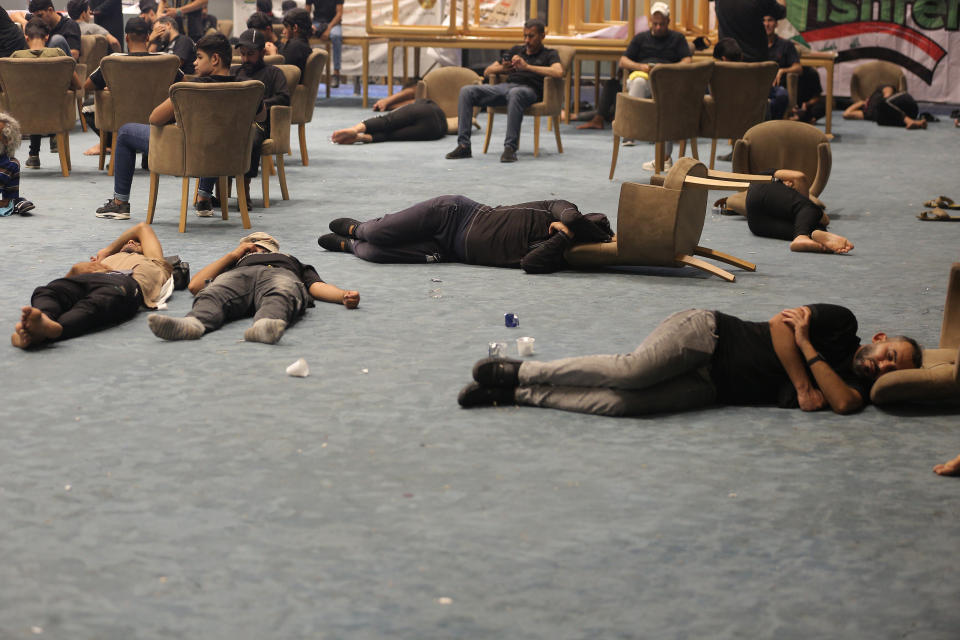 Followers of Shiite cleric Moqtada al-Sadr rest in the parliament building during a sit-in protest, in Baghdad, Iraq, Wednesday, Aug. 3, 2022. The Influential Shiite cleric has told his followers to continue their sit-in inside Iraq’s government zone, and called for the dissolution of the parliament and early elections. (AP Photo/Anmar Khalil)