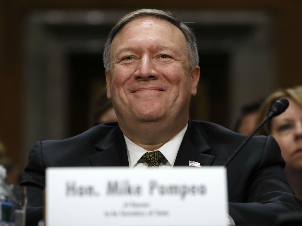 Secretary of State-designate Mike Pompeo smiles after his introduction before the Senate Foreign Relations Committee during a confirmation hearing: AP