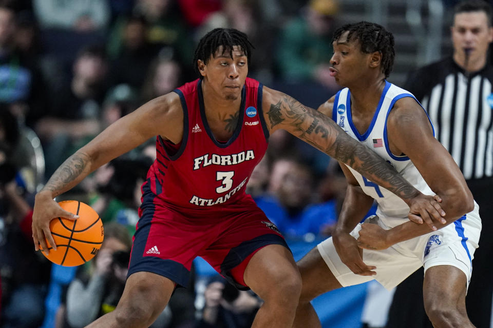 Florida Atlantic forward Giancarlo Rosado (3) drives on Memphis forward Chandler Lawson (4) in the first half of a first-round college basketball game in the men's NCAA Tournament in Columbus, Ohio, Friday, March 17, 2023. (AP Photo/Michael Conroy)