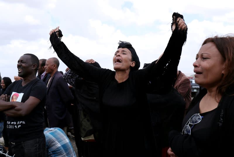 FILE PHOTO: A family member of the Ethiopian Airlines Flight ET302 plane crash victims mourns at the fenced-off accident site during the final mourning day to mark the 40th day in Gara Boka village, near Bishoftu town, southeast of Addis Abab‡