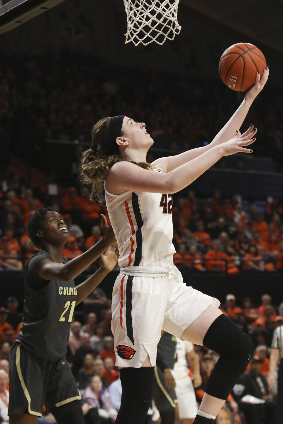 Oregon State's Kennedy Brown (42) drives to the basket past Colorado's Mya Hollingshed (21) during the first half of an NCAA college basketball game in Corvallis, Ore., Sunday, Jan. 5, 2020. (AP Photo/Amanda Loman)