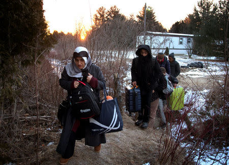 A group that claimed to be from Turkey crosses the U.S.-Canada border illegally leading into Hemmingford, Quebec, Canada March 6, 2017. REUTERS/Christinne Muschi