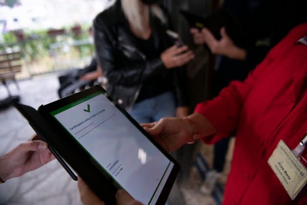 TURIN, ITALY - SEPTEMBER 13: School staff check the Green Pass for students and parents inside a school on September 13, 2021 in Turin, Italy. An estimated four million students return to school in Italy as classes reopen. The vaccine certificate, called green pass in Italy, is compulsory for teachers and for anyone accessing schools, parents included. 93% of school staff are vaccinated and two-thirds of young people between 12 and 19 have received their first dose. The gradual re-opening will see all educational institutions reopen by the 20th of September. (Photo by Stefano Guidi/Getty Images) (Photo: Stefano Guidi via Getty Images)