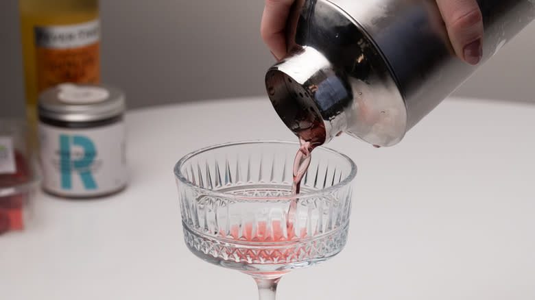 pouring drink from cocktail shaker
