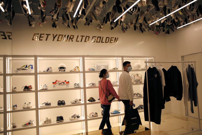 Customers wearing face masks following the COVID-19 outbreak are seen at Italian high fashion sneaker brand Golden Goose in Beijing