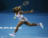 Serena Williams of the U.S. plays a baseline forehand return against Maria Sharapova of Russia during their women's singles semi-finals match at the Brisbane International tennis tournament January 3, 2014. REUTERS/Jason Reed