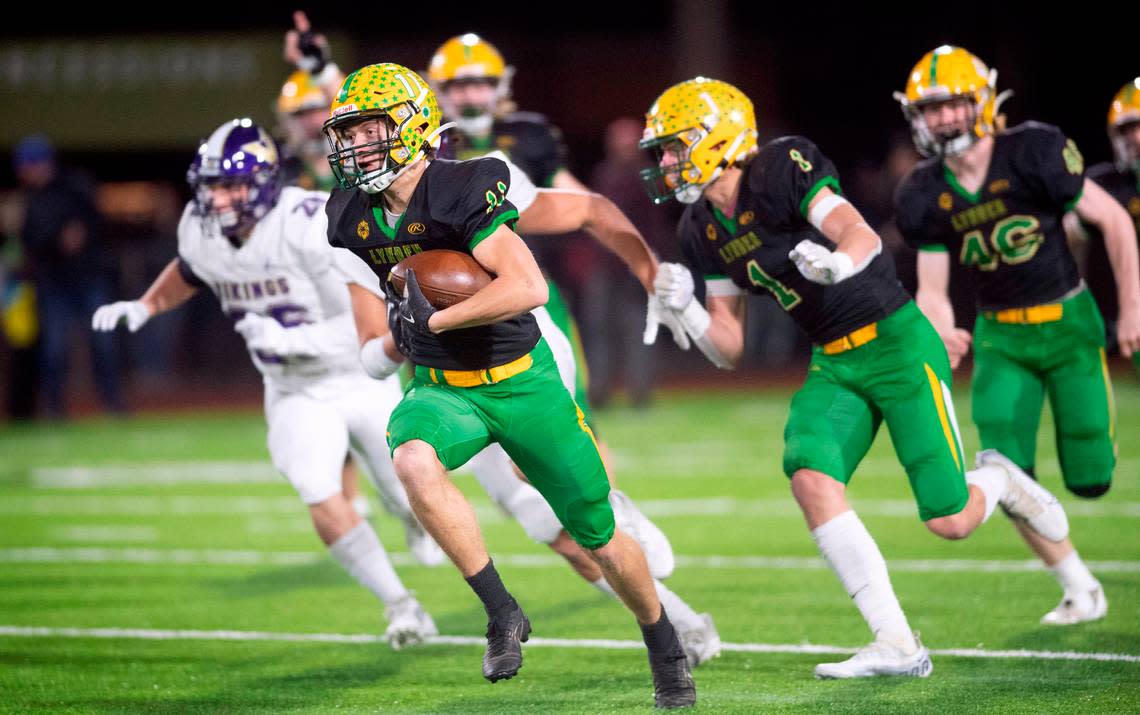 Lynden defensive back Troy Petz races to the end zone after scooping up a blocked North Kitsap field goal attempt during the 2A football state championship game at Sparks Stadium in Puyallup, Washington, on Saturday, Dec. 3, 2022.