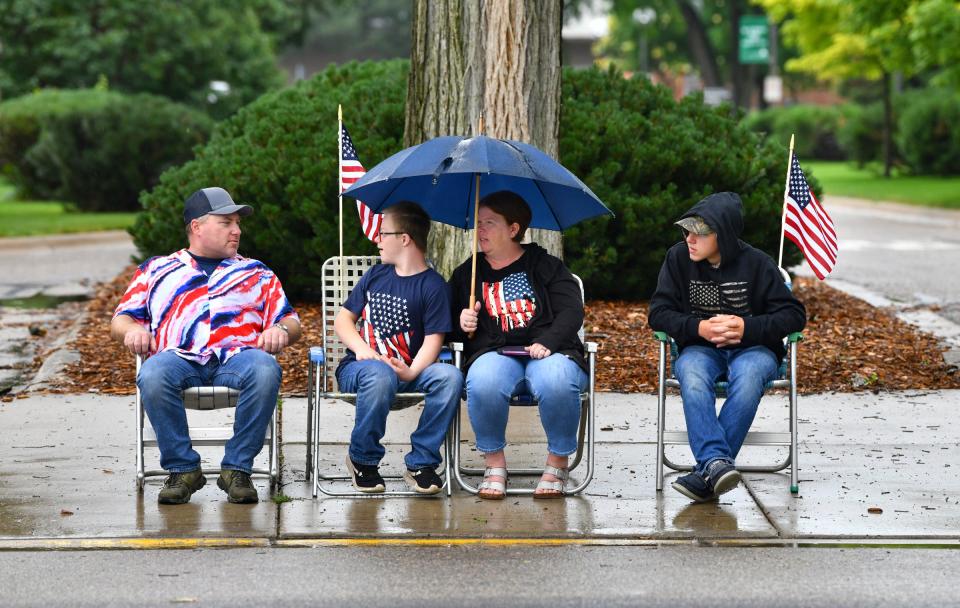 Joseph, Lelani, Marshall and Boscoe Heinen wait for the start of the St. Joseph Lions Club Fourth of July Parade as a light rain falls Monday, July 4, 2022, in downtown St. Joseph. 