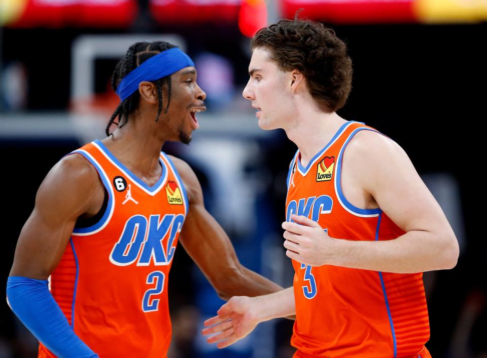 Thunder guard Shai Gilgeous-Alexander (2) congratulates Josh Giddey (3) on his 3-point basket against the Mavericks on Jan. 8 at Paycom Center.