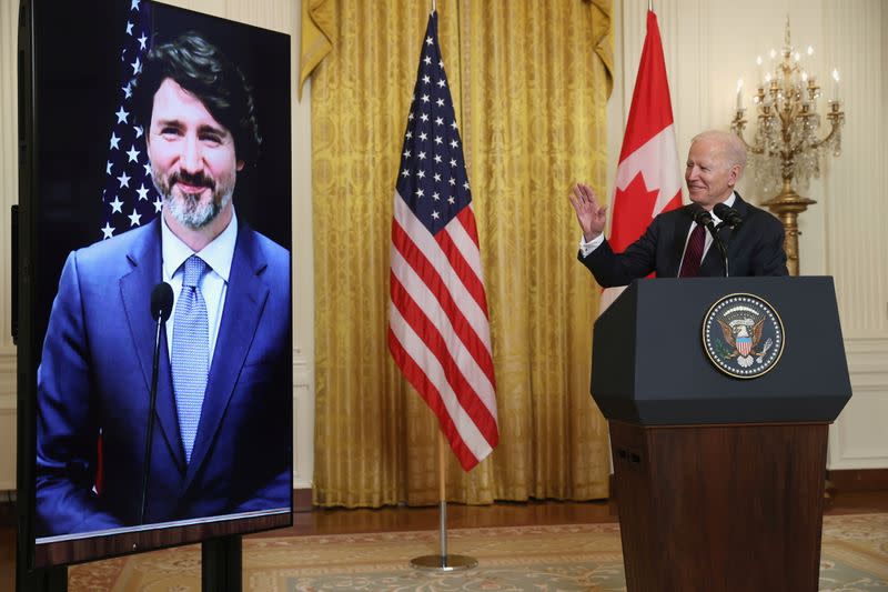 U.S. President Joe Biden gestures to Canada’s Prime Minister Justin Trudeau, appearing via video conference call, during closing remarks at the end of their virtual bilateral meeting from the White House in Washington