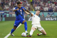 Weston McKennie of the United States, left, and England's Declan Rice fight for the ball during the World Cup group B soccer match between England and The United States, at the Al Bayt Stadium in Al Khor , Qatar, Friday, Nov. 25, 2022. (AP Photo/Ashley Landis)