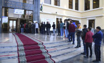 People stand in a line at a polling station during the presidential election in Tashkent, Uzbekistan, Sunday, Oct. 24, 2021. Uzbeks voted Sunday in a presidential election that the incumbent is expected to win in a landslide against weak competition. Although Shavkat Mirziyoyev has relaxed many of the policies of his dictatorial predecessor, he has made little effort at political reform. He took office in 2016 upon the death of Islam Karimov and faces four relatively low-visibility candidates who did not even show up for televised debates. (AP Photo)