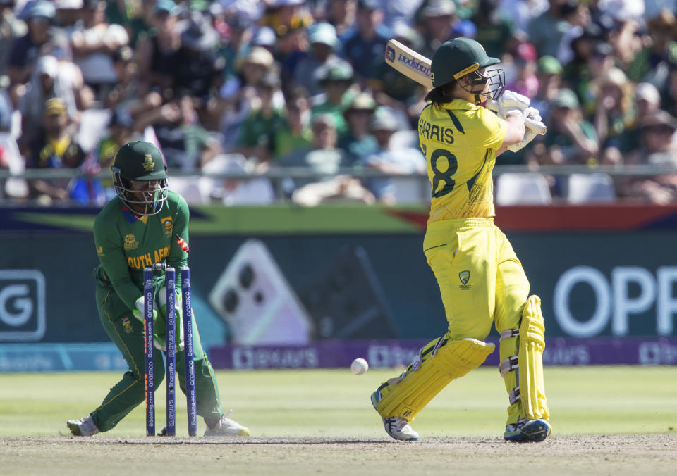 Australia's Grace Harris is bowled out while South Africa's Sinalo Jafta fields, during the Women's T20 World Cup semi final cricket match between South Africa and Australia, in Cape Town, South Africa, Sunday Feb. 26, 2023. (AP Photo/Halden Krog)
