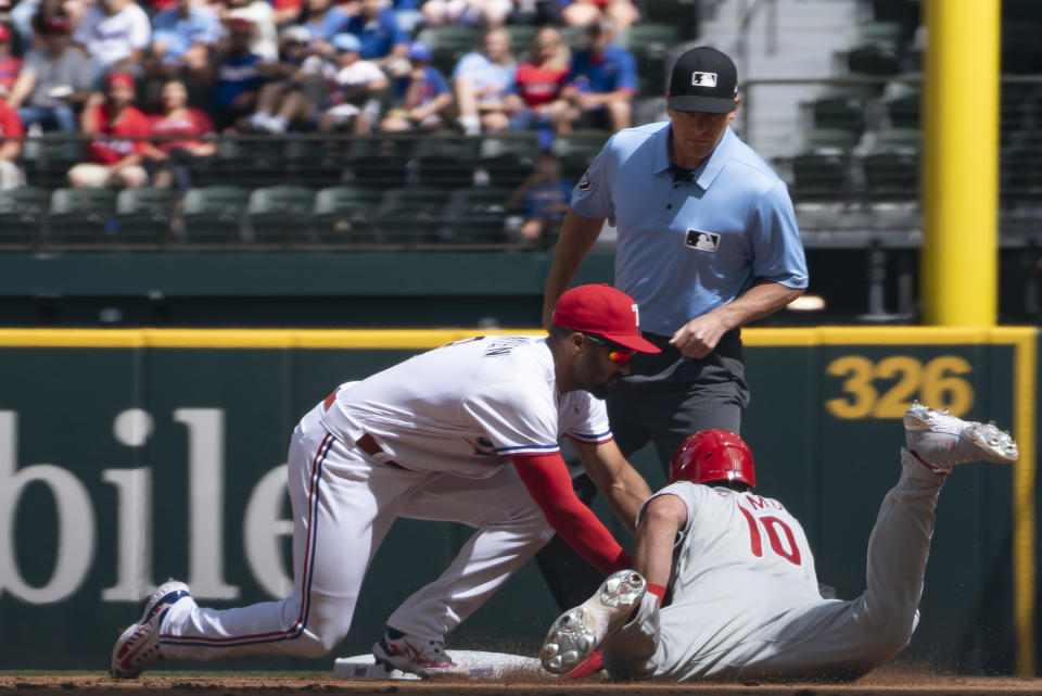 Philadelphia Phillies' J.T. Realmuto (10) is tagged out at second base by Texas Rangers second baseman Marcus Semien (2) during a baseball game in Arlington, Texas, Saturday, April 1, 2023. (AP Photo/Emil T. Lippe)