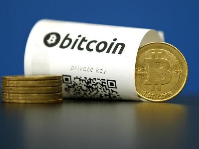 A Bitcoin (virtual currency) paper wallet with QR codes and a coin are seen in an illustration picture taken at La Maison du Bitcoin in Paris, France, May 27, 2015.  REUTERS/Benoit Tessier 