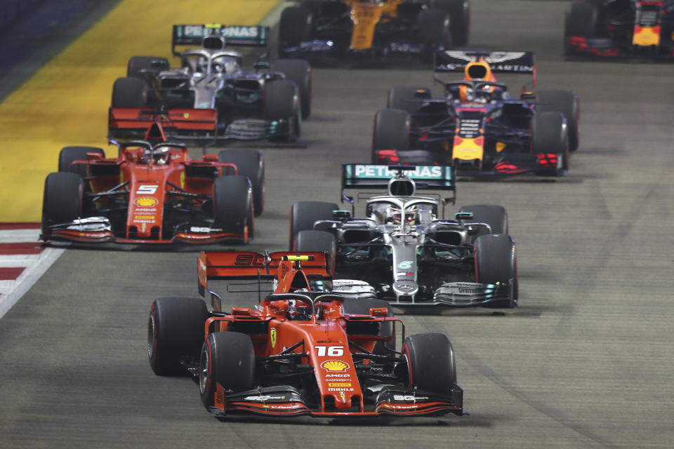 Ferrari driver Charles Leclerc of Monaco leads the field at the start of the Singapore Formula One Grand Prix, at the Marina Bay City Circuit in Singapore, Sunday, Sept. 22, 2019. (AP Photo/Lim Yong Teck)