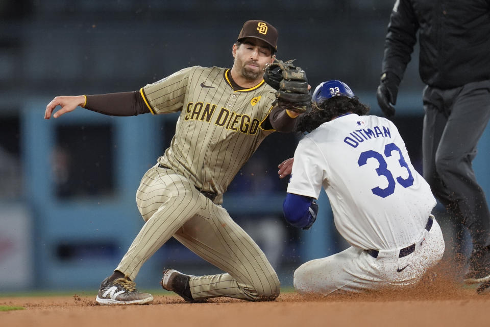 Los Angeles Dodgers' James Outman, right, steals second base past San Diego Padres second baseman Tyler Wade during the fourth inning of a baseball game Saturday, April 13, 2024, in Los Angeles. (AP Photo/Marcio Jose Sanchez)