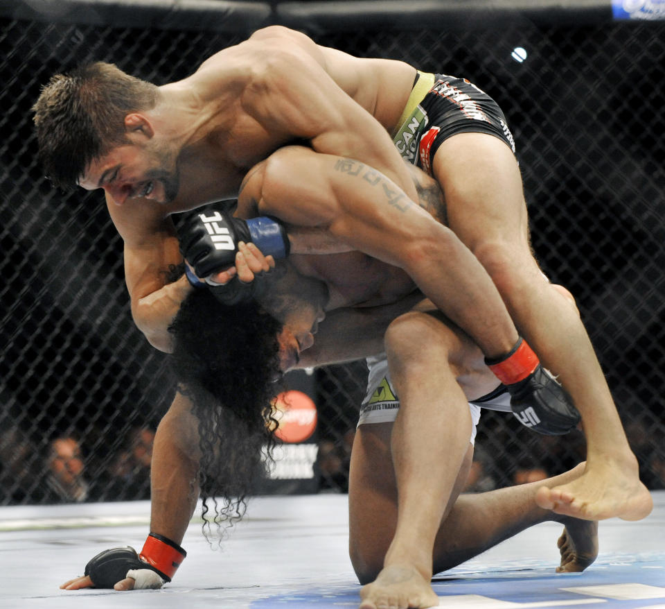 Josh Thomson, top, wrestles Benson Henderson, bottom, during the main event of the UFC mixed martial arts event in Chicago, Saturday, Jan., 25, 2014. (AP Photo/Paul Beaty)