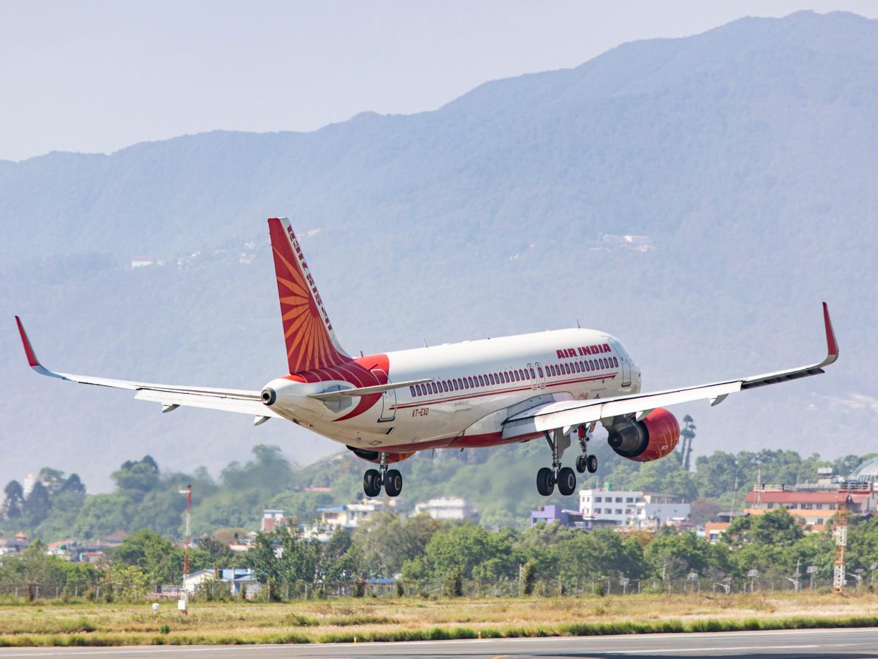 Air India Airbus A320 aircraft as seen flying over the mountains of Kathmandu valley and landing in Tribhuvan International Airport KTM.