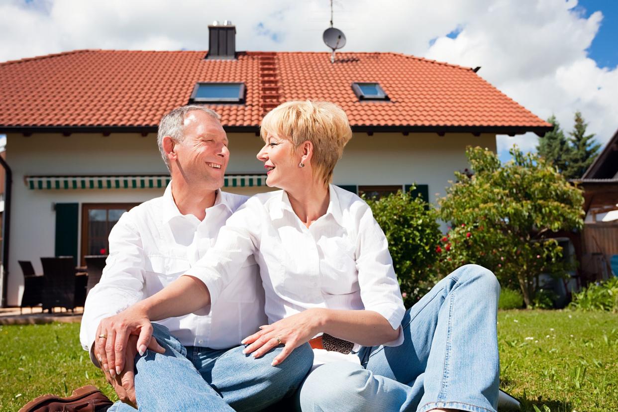 senior couple sitting in backyard