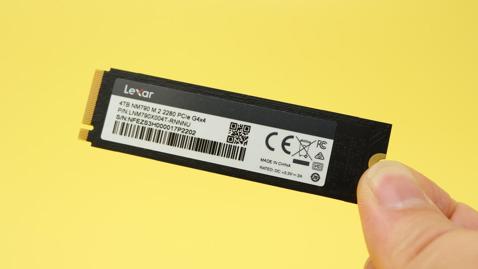 Lexar NM790 SSD on a yellow background with packaging.