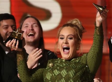 Adele breaks the Grammy for Record of the Year for "Hello" after having it presented to her at the 59th Annual Grammy Awards in Los Angeles, California, U.S., February 12, 2017. REUTERS/Lucy Nicholson