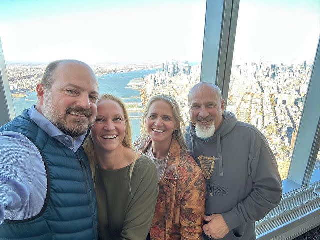 <p>Christine Brown/Instagram</p> Christine Brown and David Woolley smile with Christine's sister and brother-in-law during a trip to New York City