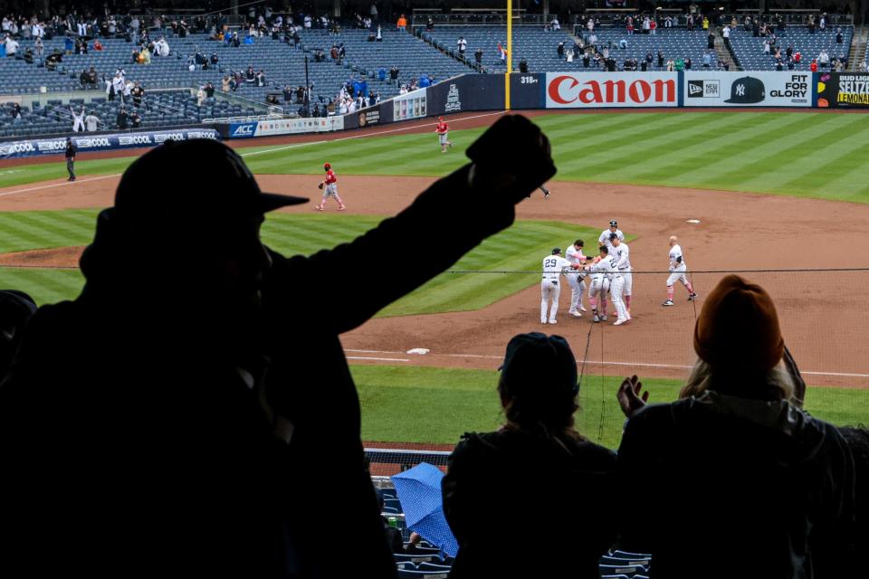 Yankees players celebrate after a win against the Nationals.