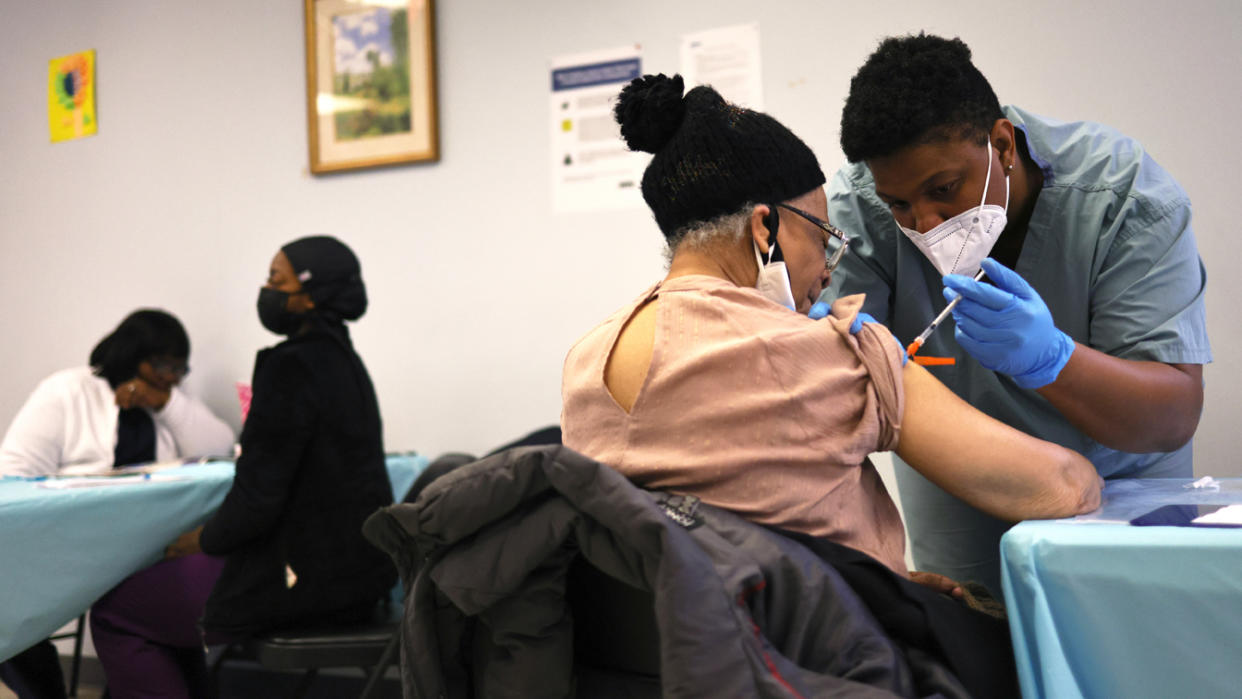 Elizabeth Griffin, 86, is given her first dose of the Moderna coronavirus (COVID-19) vaccine by Anya Harris at Red Hook Neighborhood Senior Center in the Red Hood neighborhood of the Brooklyn borough on February 22, 2021 in New York City. (Michael M. Santiago/Getty Images)