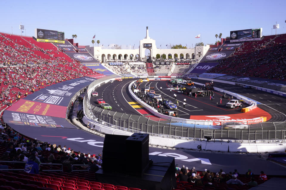 Cars race during the qualifying portion of the Busch Light Clash NASCAR exhibition auto race at Los Angeles Memorial Coliseum Sunday, Feb. 5, 2023, in Los Angeles. (AP Photo/Mark J. Terrill)