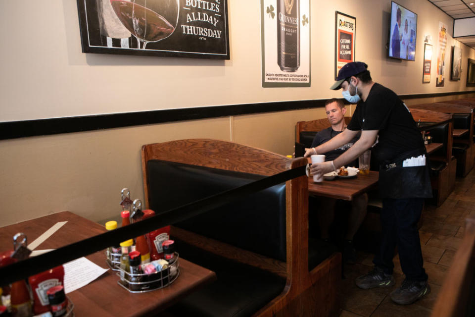 A server waits on a customer during the first day back to dine-in service in Atlanta, Georgia, this week. Source: Getty