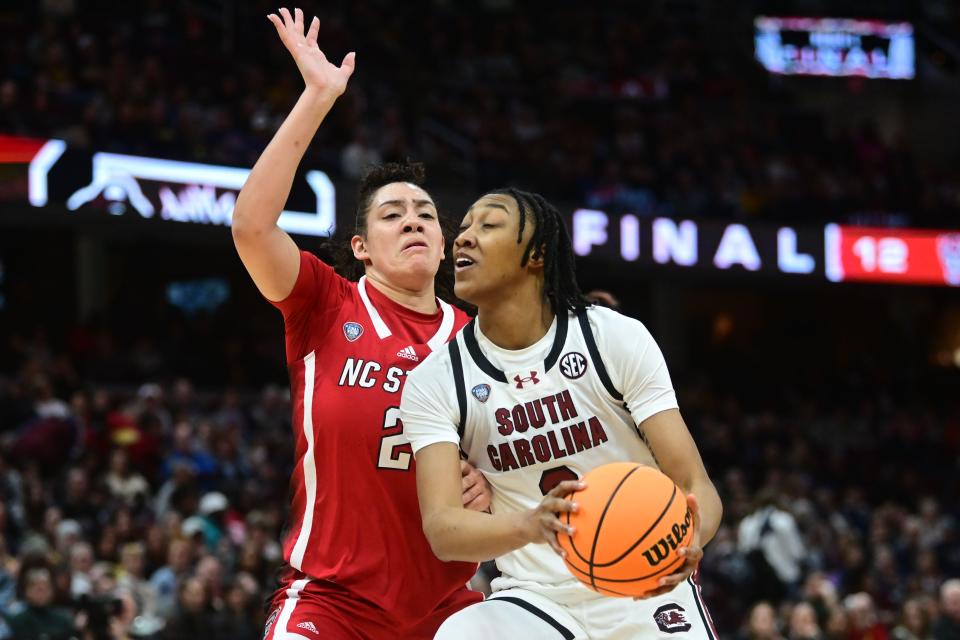 South Carolina forward Ashlyn Watkins (2) dribbles the ball around North Carolina State forward Mimi Collins (2) during Friday's national semifinal game at Rocket Mortgage FieldHouse.