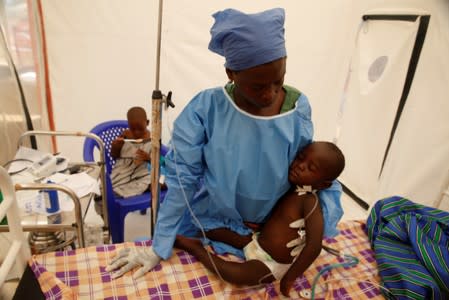 FILE PHOTO: Ebola survivor Jeanine Masika Mbuka Furana Katung? holds Furana Katungu, a two-year-old confirmed ebola patient, inside the Biosecure Emergency Care Unit at the ALIMA Ebola treatment centre in Beni