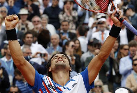 David Ferrer of Spain celebrates after defeating his compatriot Rafael Nadal during their quarter-final match at the Monte Carlo Masters in Monaco April 18, 2014. REUTERS/Eric Gaillard