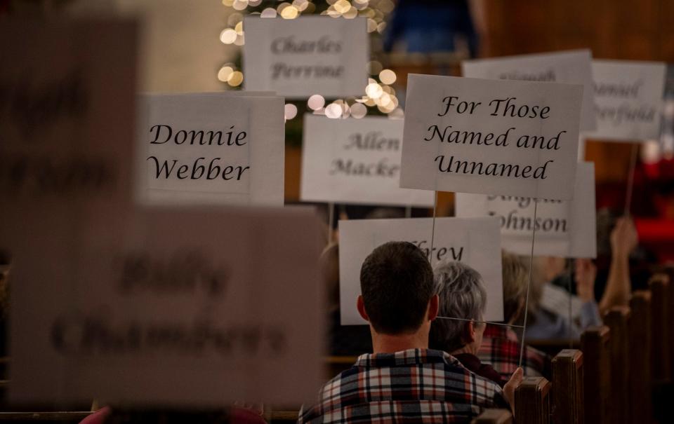 The sign "For Those Named and Unnamed" stands among many others during the Homeless Memorial Vigil held by Beacon Inc. at First Christian Church on Wednesday, Dec. 13, 2023.