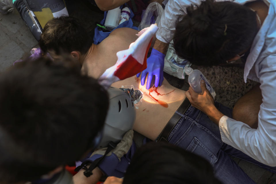 An injured demonstrator receives medical attention during an anti-government protest in Santiago, Chile on Oct. 28, 2019. (Photo: Pablo Sanhueza/Reuters)