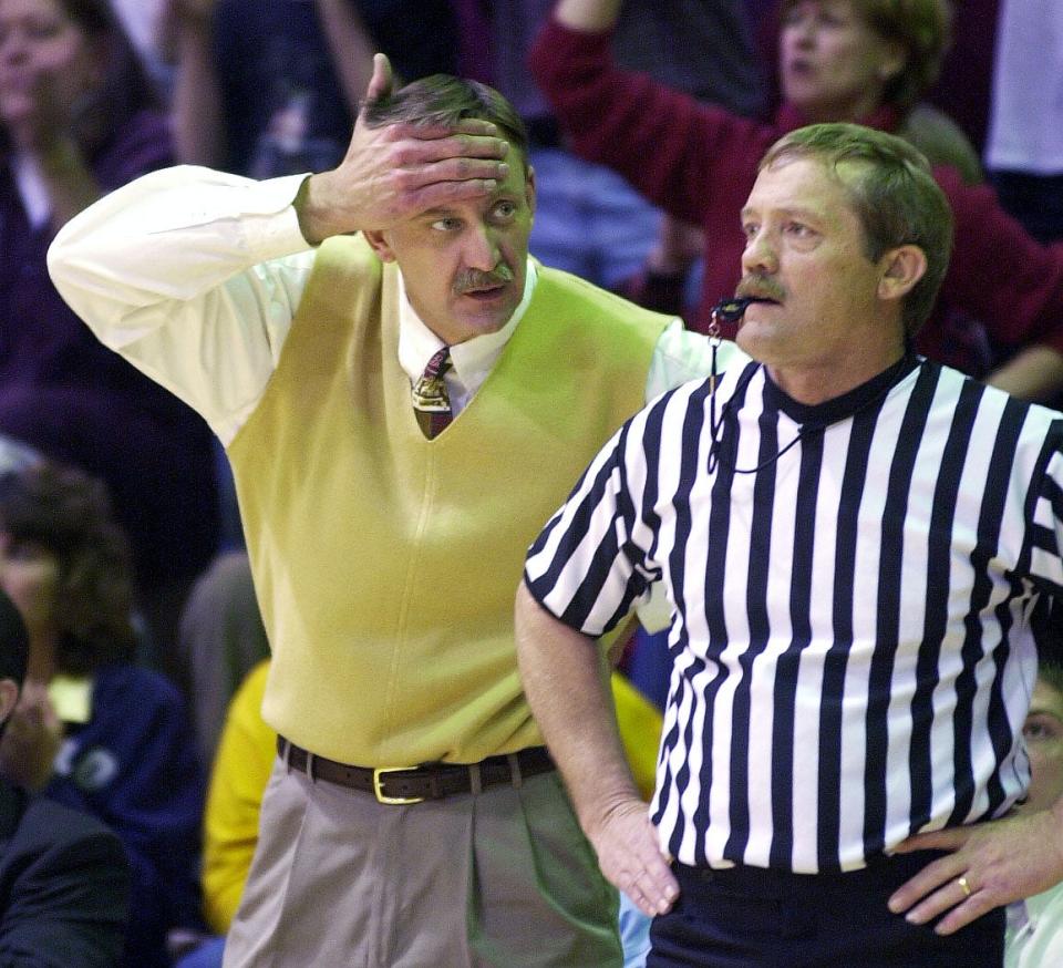 Henderson County Colonel head coach Phil Gibson talks to referee B.F. Behrendt during the 2002 Second Region championship game in Madisonville.