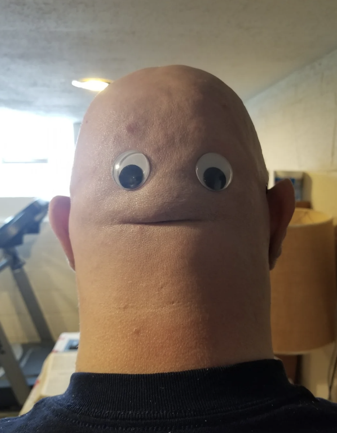 googly eyes on the back of a man's head