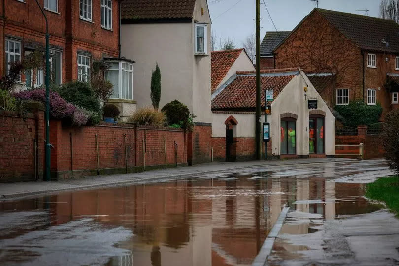 A general view of an area of flooding in Main Street, Lambley, with puddle on street