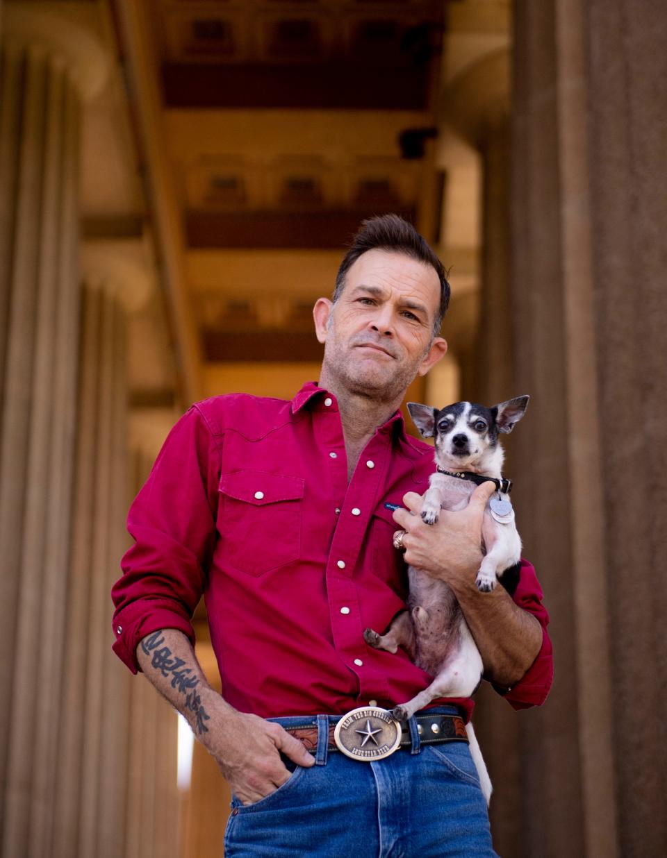 Waylon Payne stands with his dog, Petey, at the Parthenon at Centennial Park in Nashville , Tenn., Monday, Sept. 4, 2023.