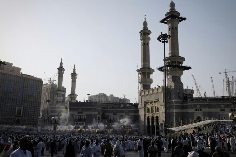 Muslim pilgrims arriving for the evening prayer at Mecca's Grand Mosque, home of the cube-shaped Kaaba or "House of God", on September 29, 2014 during the annual hajj pilgrimage