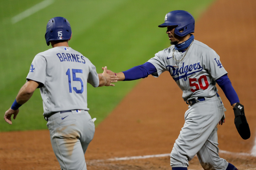 DENVER, COLORADO - SEPTEMBER 18: Austin Barnes #15 and Mookie Betts #50 of the Los Angeles Dodgers celebrate.