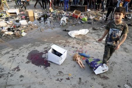 A boy walks at the site of suicide blasts in Baghdad's Sadr City February 28, 2016. REUTERS/Wissm al-Okili