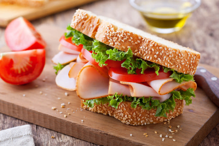 A sandwich with thick slices of tomatoe