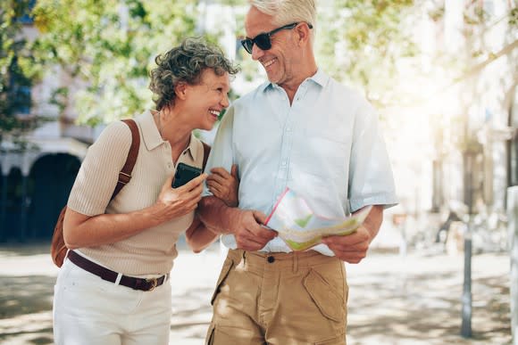 A senior couple walking on a street.