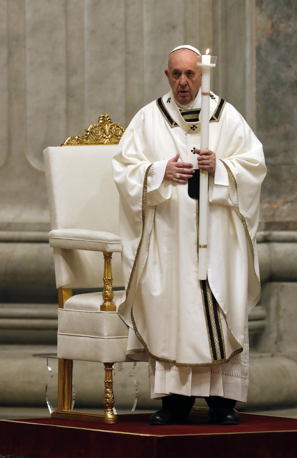 Pope Francis presides over a solemn Easter vigil ceremony in St. Peter's Basilica empty of the faithful following Italy’s ban on gatherings to contain coronavirus contagion, at the Vatican, Saturday, April 11, 2020. The new coronavirus causes mild or moderate symptoms for most people, but for some, especially older adults and people with existing health problems, it can cause more severe illness or death. (Remo Casilli/Pool Photo via AP)