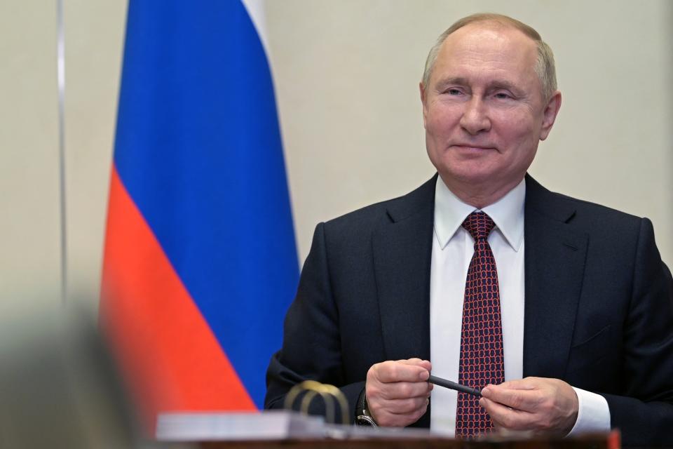 Russian President Vladimir Putin talks with members of Russia's national team ahead of the Beijing 2022 Winter Olympics, via a videoconference at the Novo-Ogaryovo residence outside Moscow, Russia, Tuesday, Jan. 25, 2022. (Alexei Nikolsky, Sputnik, Kremlin Pool Photo via AP)