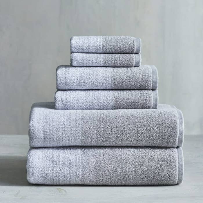 set of grey towels on top of each other from small to large