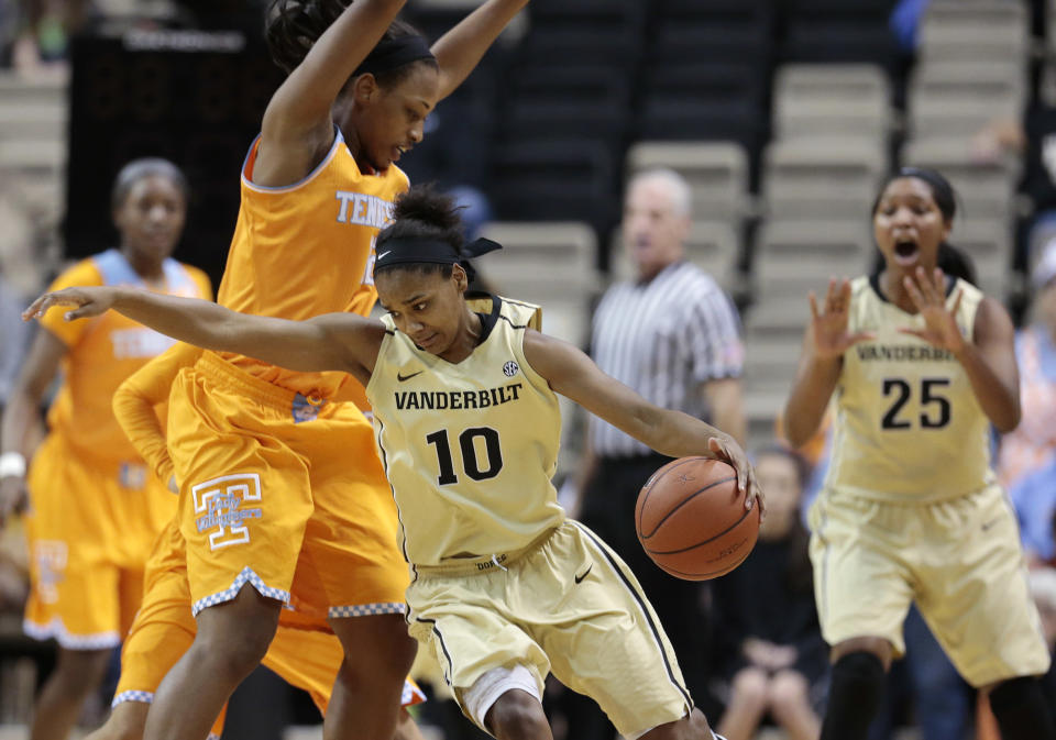 Vanderbilt guard Christina Foggie (10) drives around Tennessee forward Bashaara Graves in the first half of an NCAA college basketball game on Sunday, Jan. 12, 2014, in Nashville, Tenn. (AP Photo/Mark Humphrey)